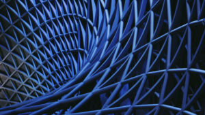 DM placeholder 2a | DavidsonMorris Close-up of a blue metal lattice with diagonal bars creating a crisscross pattern.