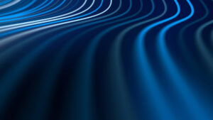 Abstract blue curves forming a flowing wave pattern on a dark background in navy tones with light streaks of blueiness.